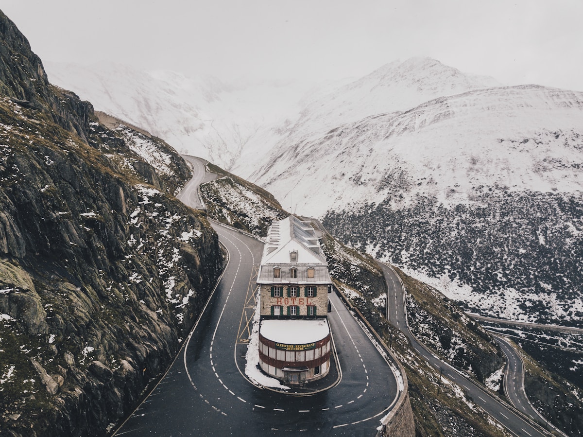 High mountain pass road with sharp bends and glacier views